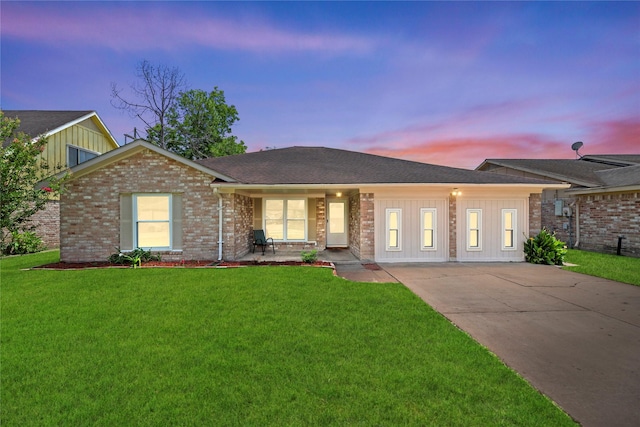 12211 Pine Knoll Dr, Houston, TX 77099 - view of front of house with a lawn, board and batten siding, and driveway