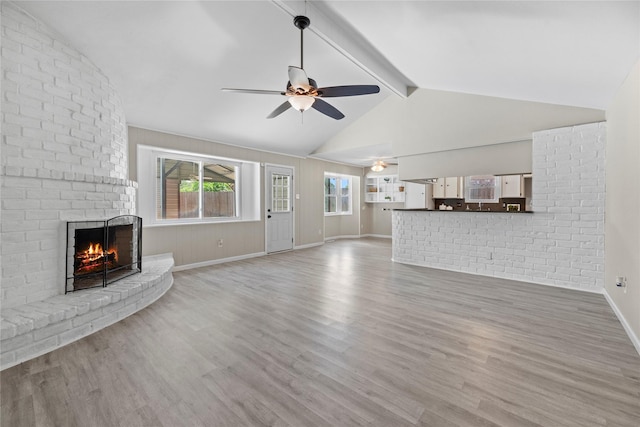12211 Pine Knoll Dr, Houston, TX 77099 - unfurnished living room with a ceiling fan, a fireplace, and wood finished floors