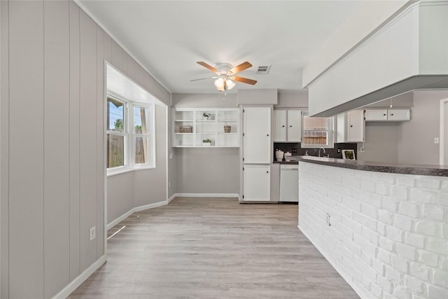 12211 Pine Knoll Dr, Houston, TX 77099 - kitchen with white dishwasher, a ceiling fan, dark countertops, white cabinetry, and light wood-style floors