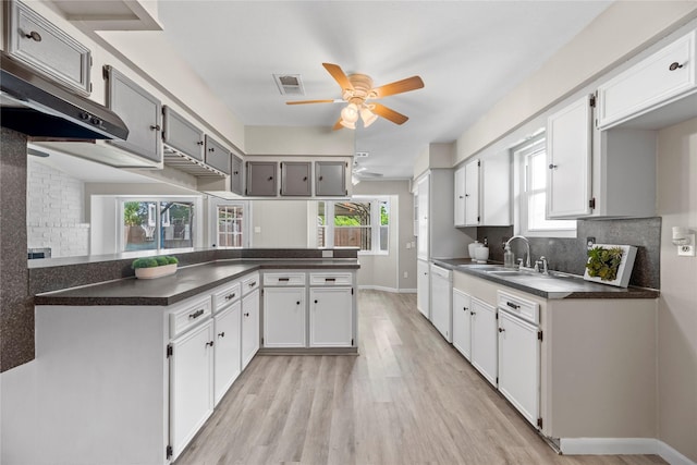 12211 Pine Knoll Dr, Houston, TX 77099 - kitchen with dark countertops, a ceiling fan, tasteful backsplash, and light wood finished floors