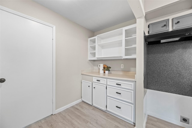 12211 Pine Knoll Dr, Houston, TX 77099 - kitchen with light wood finished floors, white cabinetry, light countertops, and open shelves