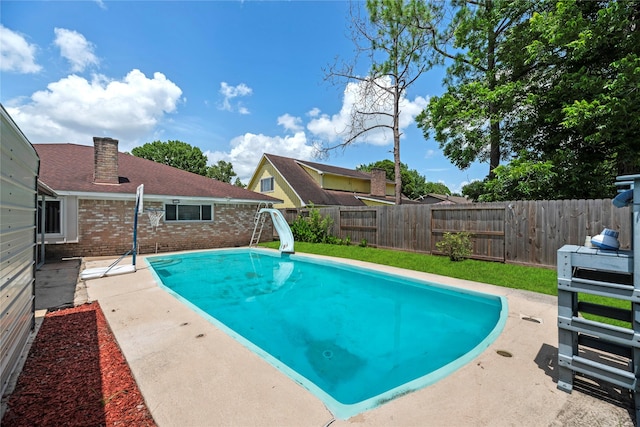 12211 Pine Knoll Dr, Houston, TX 77099 - view of pool with a water slide, a fenced backyard, and a patio