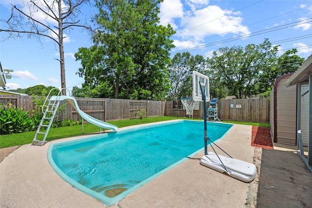 12211 Pine Knoll Dr, Houston, TX 77099 - view of pool with a water slide, a fenced backyard, and a patio area
