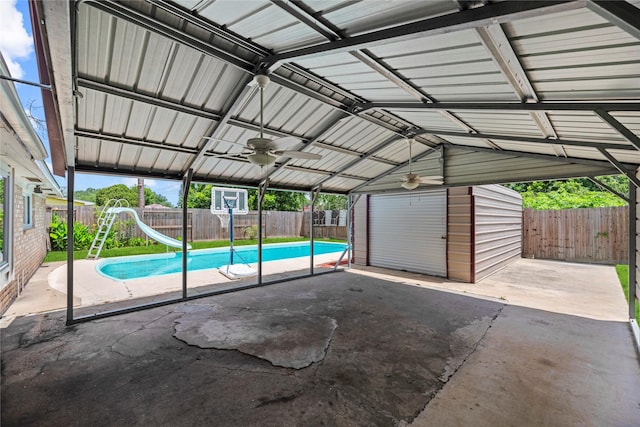12211 Pine Knoll Dr, Houston, TX 77099 - view of swimming pool with a water slide, an outdoor structure, a fenced backyard, and ceiling fan