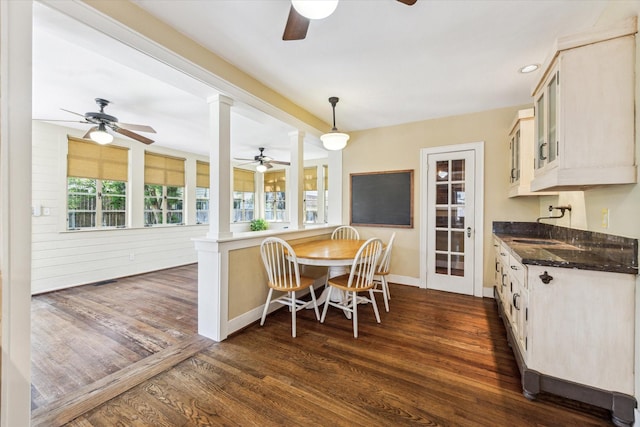 1731 Marshall St, Houston, TX 77098 - dining space featuring ceiling fan, ornate columns, and dark wood-style flooring