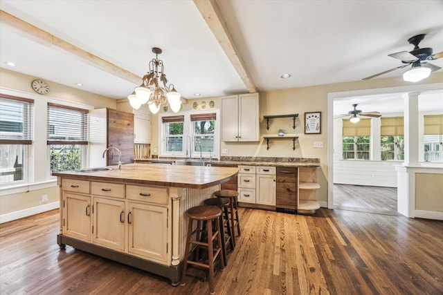 1731 Marshall St, Houston, TX 77098 - kitchen with wooden counters, an island with sink, beam ceiling, a ceiling fan, and dark wood finished floors