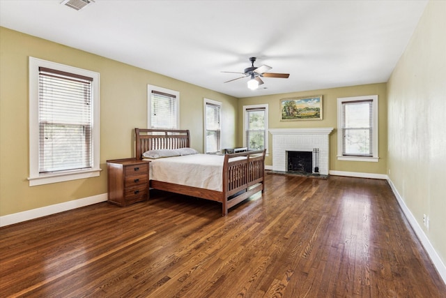 1731 Marshall St, Houston, TX 77098 - bedroom with dark wood finished floors, a brick fireplace, and ceiling fan