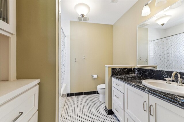 1731 Marshall St, Houston, TX 77098 - bathroom with vanity, tile patterned floors, and shower / tub combo with curtain