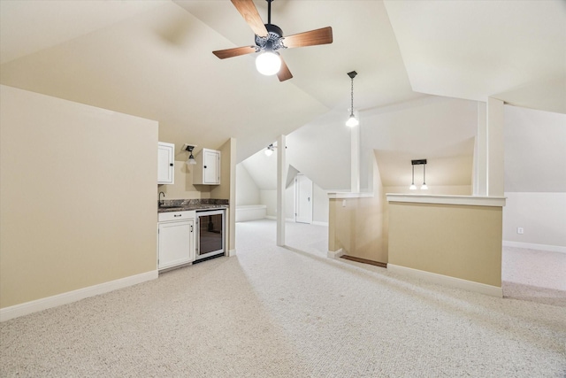 1731 Marshall St, Houston, TX 77098 - unfurnished living room featuring beverage cooler, vaulted ceiling, light carpet, and a ceiling fan