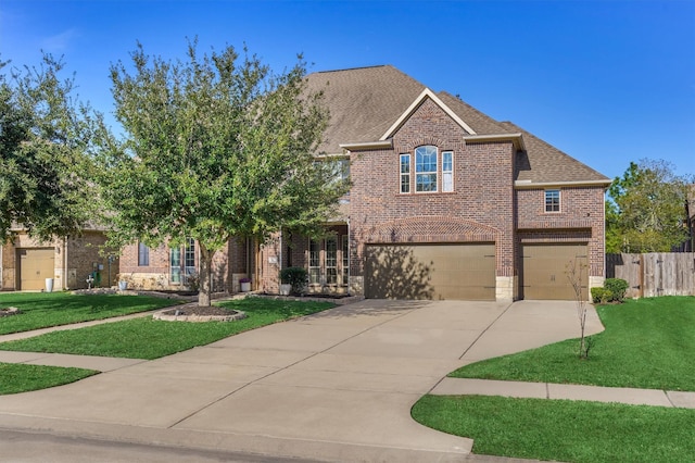 20210 Mariposa Blue Ln, Cypress, TX 77433 - view of front of house featuring brick siding, an attached garage, concrete driveway, and roof with shingles