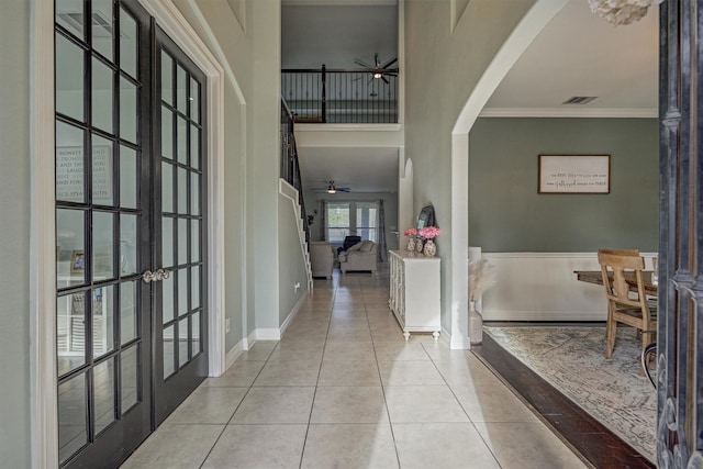 20210 Mariposa Blue Ln, Cypress, TX 77433 - tiled entrance foyer with ceiling fan, french doors, arched walkways, crown molding, and a high ceiling
