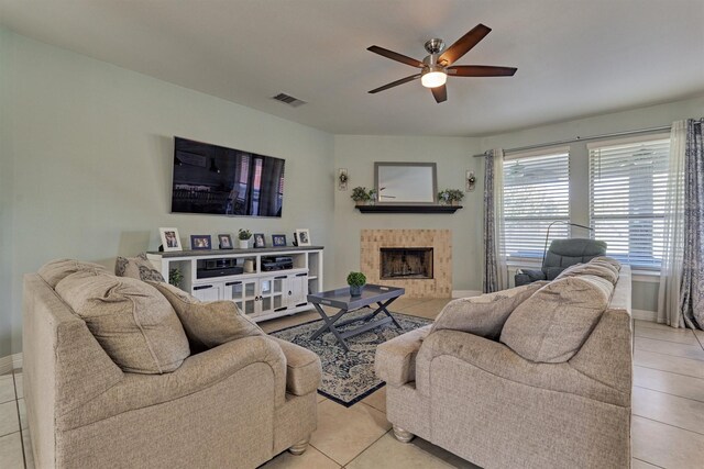 20210 Mariposa Blue Ln, Cypress, TX 77433 - living area with light tile patterned floors, a fireplace, and a ceiling fan