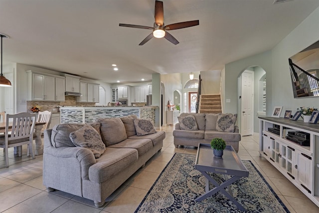 20210 Mariposa Blue Ln, Cypress, TX 77433 - living area featuring arched walkways, stairs, a ceiling fan, light tile patterned floors, and recessed lighting