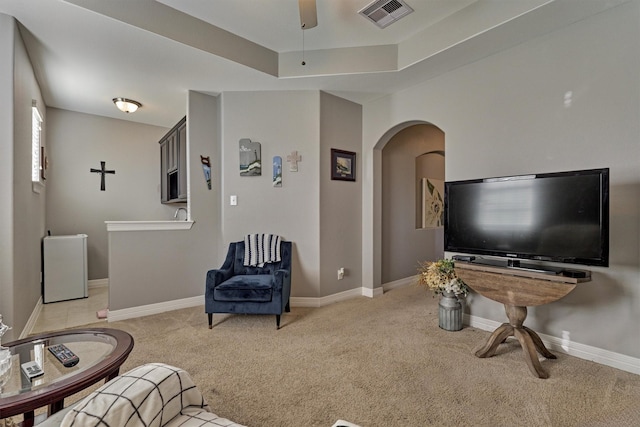 20210 Mariposa Blue Ln, Cypress, TX 77433 - living area with light carpet, arched walkways, ceiling fan, and a tray ceiling