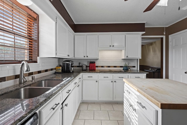 6995 Limerick Dr, Beaumont, TX 77706 - kitchen with a ceiling fan, backsplash, white cabinets, and ornamental molding