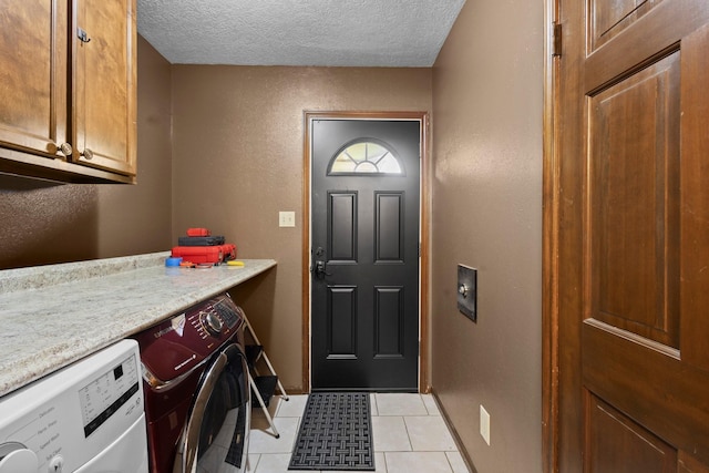 6995 Limerick Dr, Beaumont, TX 77706 - laundry room featuring cabinet space, separate washer and dryer, a textured ceiling, and light tile patterned floors