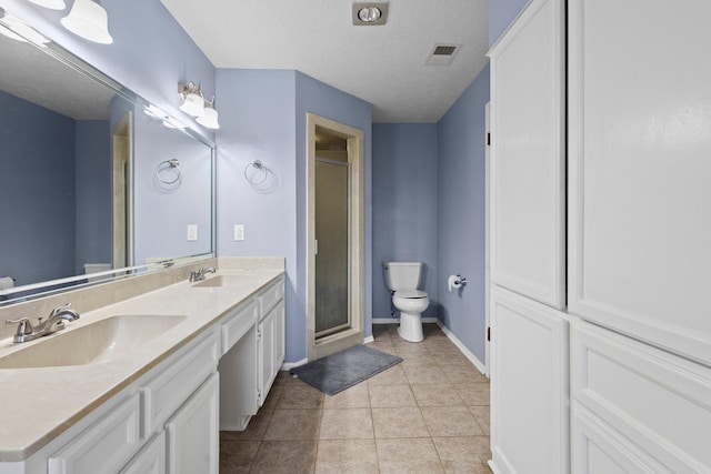 6995 Limerick Dr, Beaumont, TX 77706 - bathroom featuring a shower stall, double vanity, tile patterned floors, and a textured ceiling