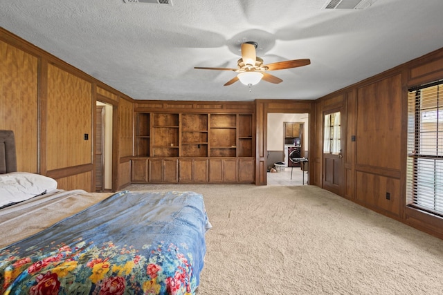 6995 Limerick Dr, Beaumont, TX 77706 - carpeted bedroom with wood walls and a ceiling fan