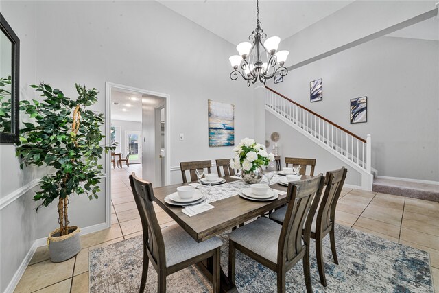 22406 Cascade Springs Dr, Katy, TX 77494 - dining room with high vaulted ceiling, stairway, light tile patterned floors, and a chandelier