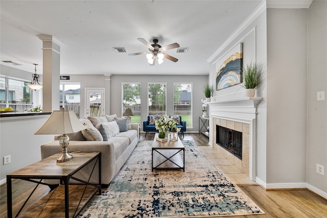 22406 Cascade Springs Dr, Katy, TX 77494 - living area featuring plenty of natural light, light wood-type flooring, a ceiling fan, and a tile fireplace