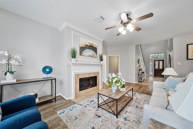 22406 Cascade Springs Dr, Katy, TX 77494 - living room with ceiling fan, a tiled fireplace, and wood finished floors