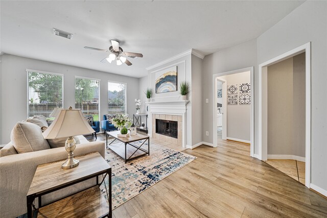 22406 Cascade Springs Dr, Katy, TX 77494 - living room with a fireplace, ceiling fan, and wood finished floors