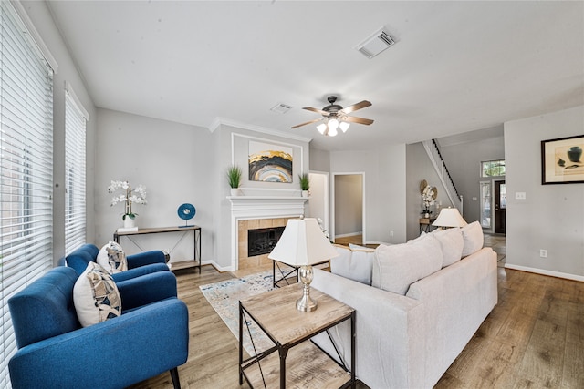 22406 Cascade Springs Dr, Katy, TX 77494 - living area with wood finished floors, ceiling fan, a tile fireplace, and healthy amount of natural light
