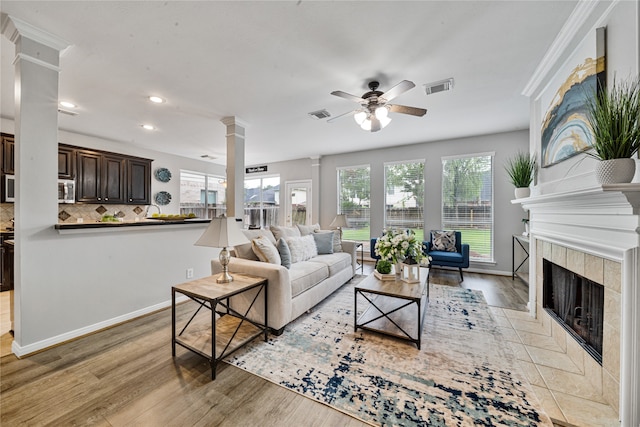 22406 Cascade Springs Dr, Katy, TX 77494 - living area featuring decorative columns, ceiling fan, healthy amount of natural light, recessed lighting, and a fireplace