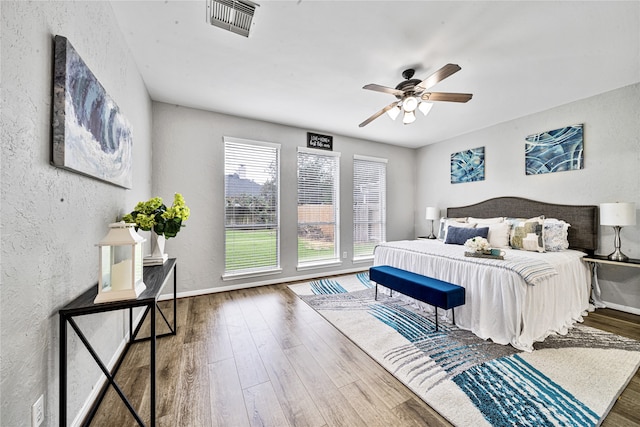 22406 Cascade Springs Dr, Katy, TX 77494 - bedroom featuring a textured wall, wood finished floors, and ceiling fan