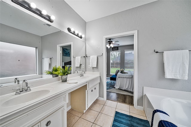 22406 Cascade Springs Dr, Katy, TX 77494 - full bathroom featuring double vanity, a bath, tile patterned floors, ensuite bathroom, and ceiling fan