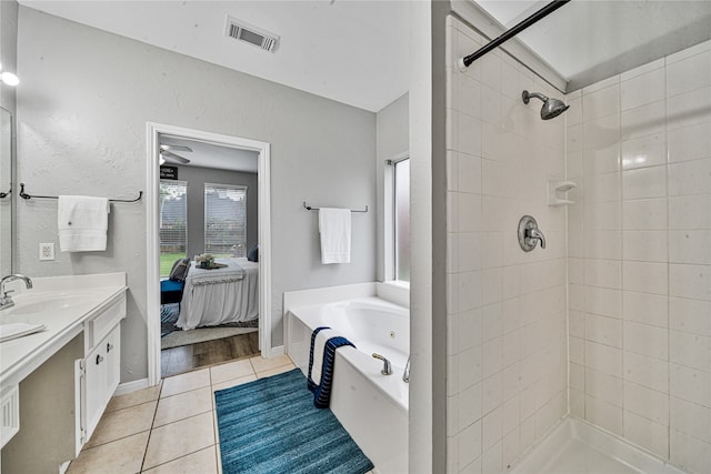 22406 Cascade Springs Dr, Katy, TX 77494 - bathroom featuring vanity, a jetted tub, ensuite bath, tile patterned flooring, and a tile shower