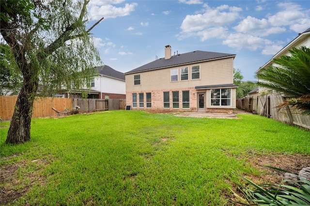 22406 Cascade Springs Dr, Katy, TX 77494 - back of property featuring a fenced backyard, a chimney, and a patio