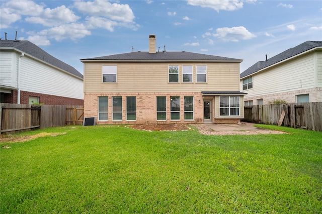 22406 Cascade Springs Dr, Katy, TX 77494 - rear view of house featuring brick siding, a patio area, a fenced backyard, and a chimney