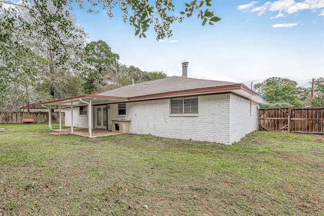 2307 N Thompson, Conroe, TX 77303 - back of house featuring french doors, a patio, a fenced backyard, and brick siding