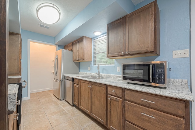 2307 N Thompson, Conroe, TX 77303 - kitchen featuring stainless steel appliances and light tile patterned flooring