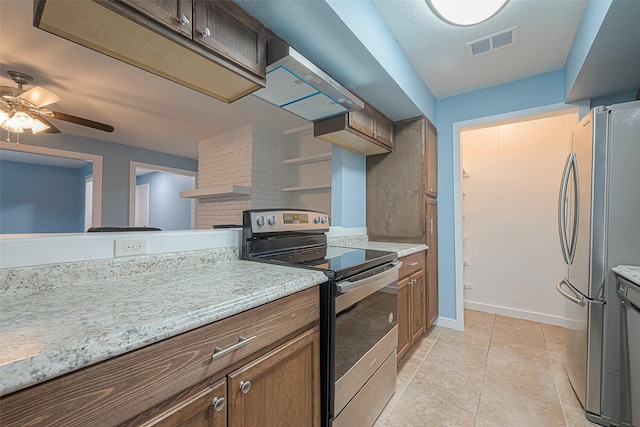 2307 N Thompson, Conroe, TX 77303 - kitchen featuring appliances with stainless steel finishes, ceiling fan, and wall chimney range hood