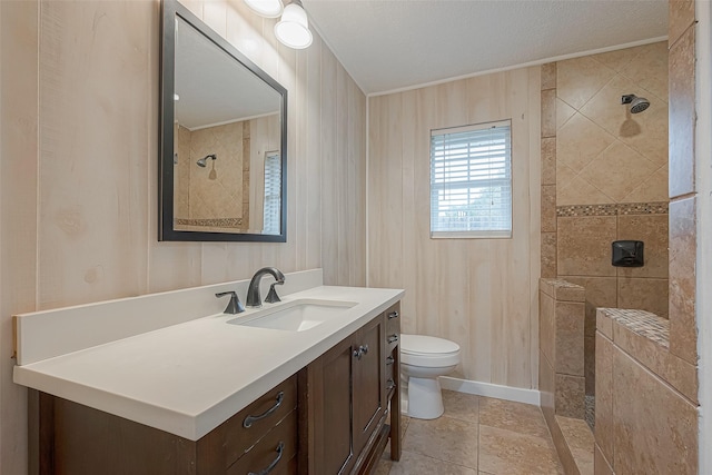 2307 N Thompson, Conroe, TX 77303 - full bathroom featuring tiled shower, vanity, crown molding, tile patterned floors, and a textured ceiling