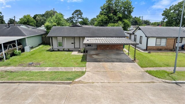 3112 Hays St, Pasadena, TX 77503 - ranch-style home featuring driveway, a front lawn, brick siding, and a carport