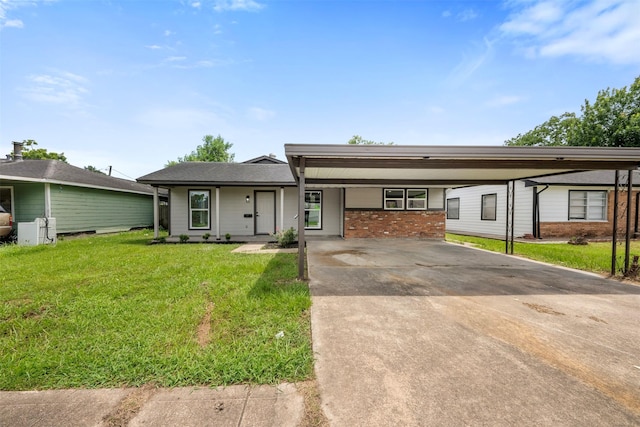 3112 Hays St, Pasadena, TX 77503 - view of front of house with a front lawn, a carport, concrete driveway, and brick siding