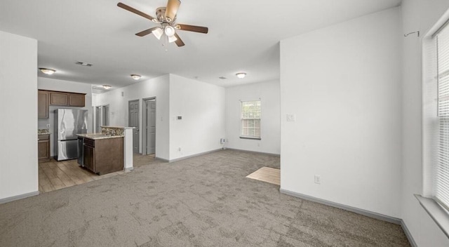 235 Calloway St, Houston, TX 77029 - unfurnished living room featuring light colored carpet and a ceiling fan