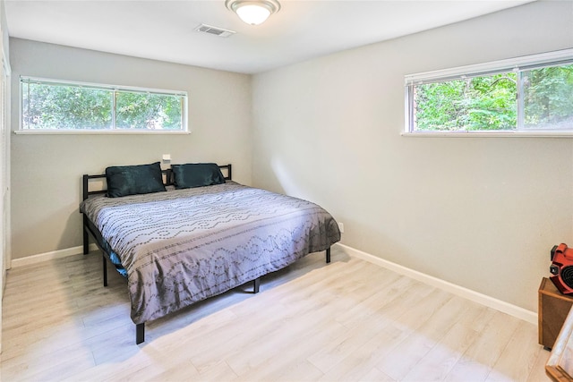 2706 Meadow Ln, La Marque, TX 77568 - bedroom featuring multiple windows and wood finished floors