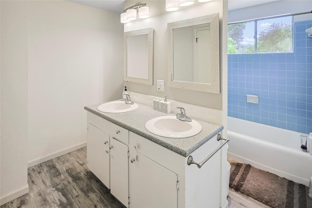 2706 Meadow Ln, La Marque, TX 77568 - bathroom with double vanity, wood finished floors, and shower / bathtub combination