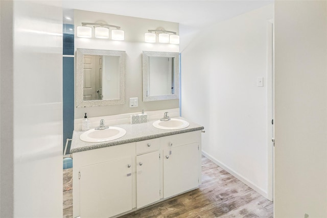 2706 Meadow Ln, La Marque, TX 77568 - bathroom featuring double vanity and wood finished floors