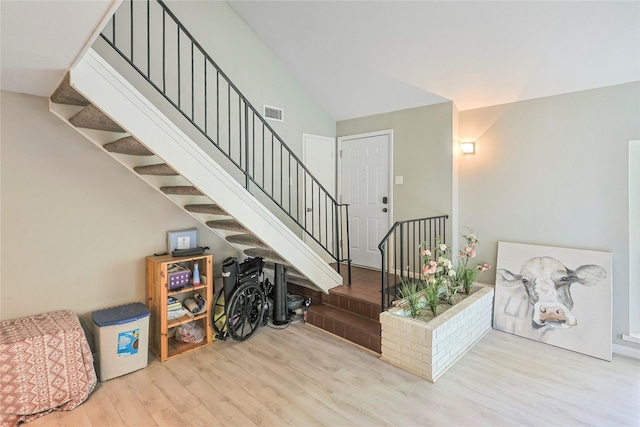 2706 Meadow Ln, La Marque, TX 77568 - staircase with wood finished floors and vaulted ceiling