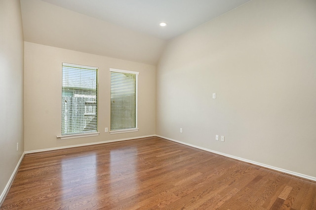 13604 Rainwater Dr, Pearland, TX 77584 - spare room featuring wood finished floors, lofted ceiling, and recessed lighting