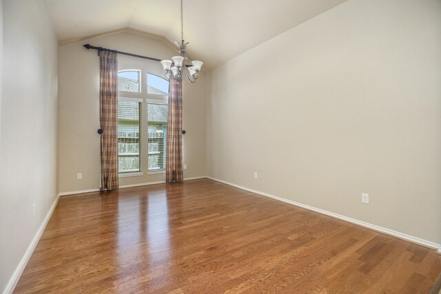 13604 Rainwater Dr, Pearland, TX 77584 - spare room with a chandelier, wood finished floors, and lofted ceiling