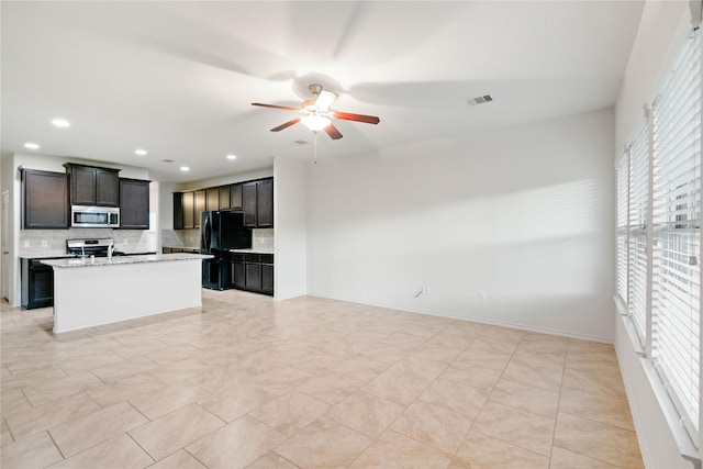 182 Meadow Grove Dr, Conroe, TX 77384 - kitchen with stainless steel microwave, plenty of natural light, decorative backsplash, freestanding refrigerator, and recessed lighting