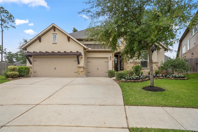 31218 Redwood Manor Ct, Spring, TX 77386 - view of front of property featuring stucco siding, stone siding, and concrete driveway