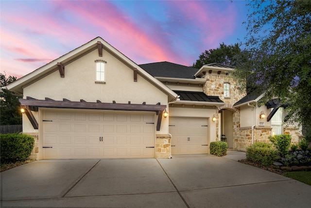 31218 Redwood Manor Ct, Spring, TX 77386 - view of front of property with stone siding, concrete driveway, a standing seam roof, stucco siding, and a garage