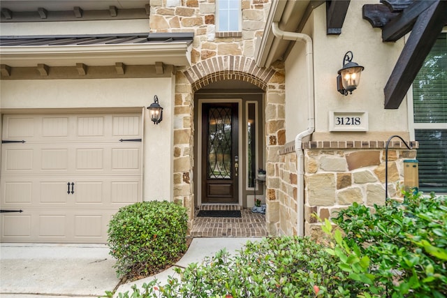 31218 Redwood Manor Ct, Spring, TX 77386 - entrance to property with stone siding, a standing seam roof, an attached garage, stucco siding, and a metal roof